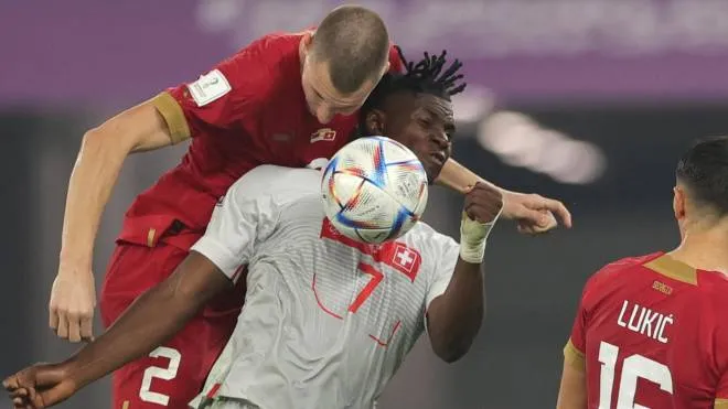 epa10345264 Strahinja Pavlovic (L) of Serbia in action against Breel Embolo of Switzerland during the FIFA World Cup 2022 group G soccer match between Serbia and Switzerland at Stadium 947 in Doha, Qatar, 02 December 2022.  EPA/Friedemann Vogel