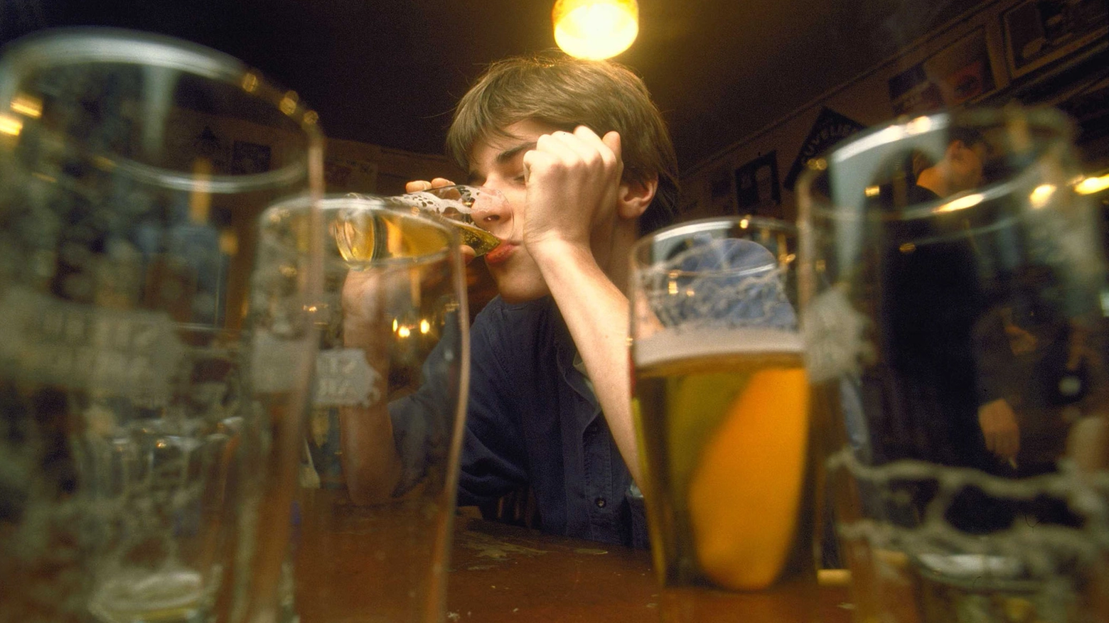 Un ragazzo beve birra