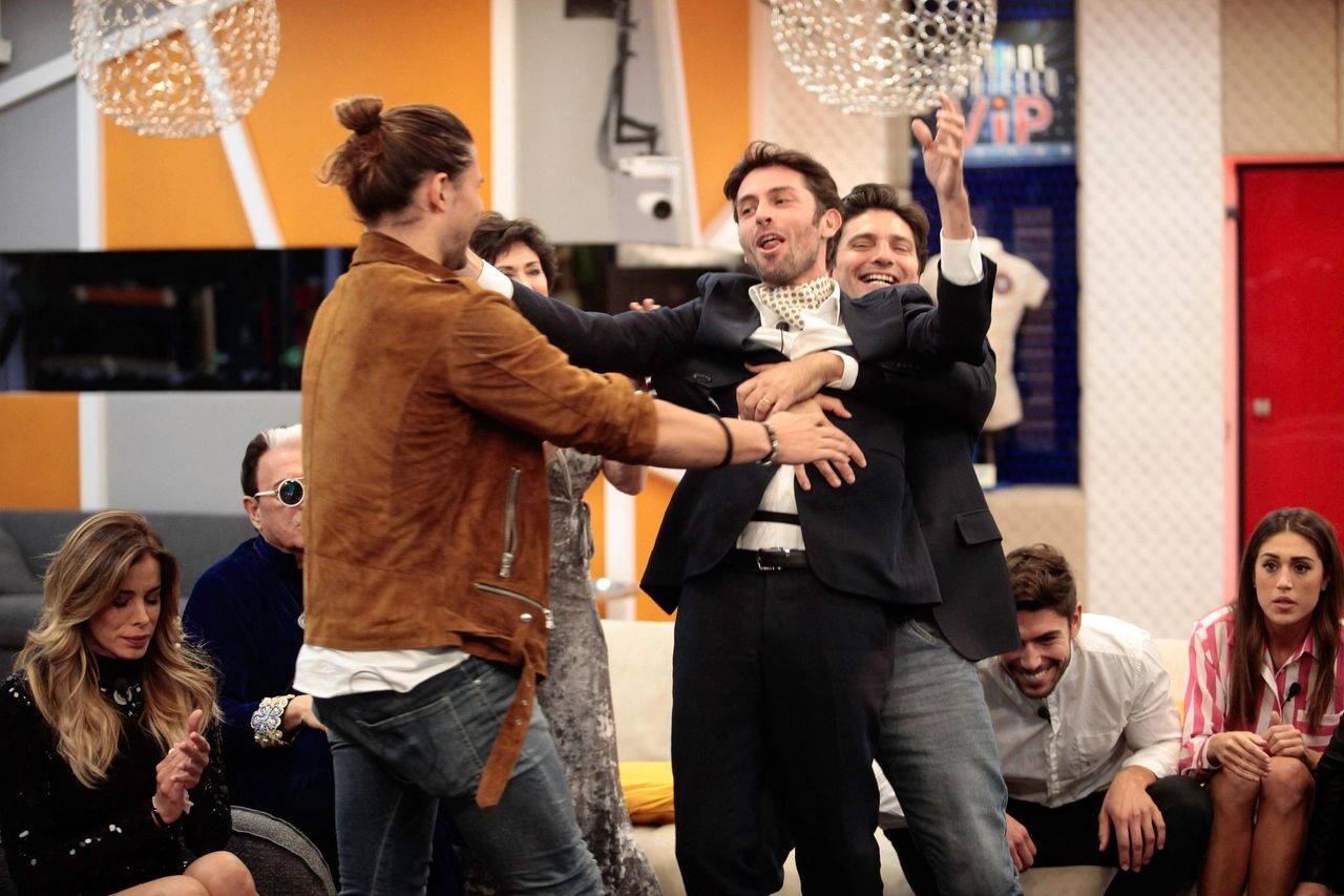 Raffaello Tonon abbracciato da Luca Onestini e Lorenzo Flaherty