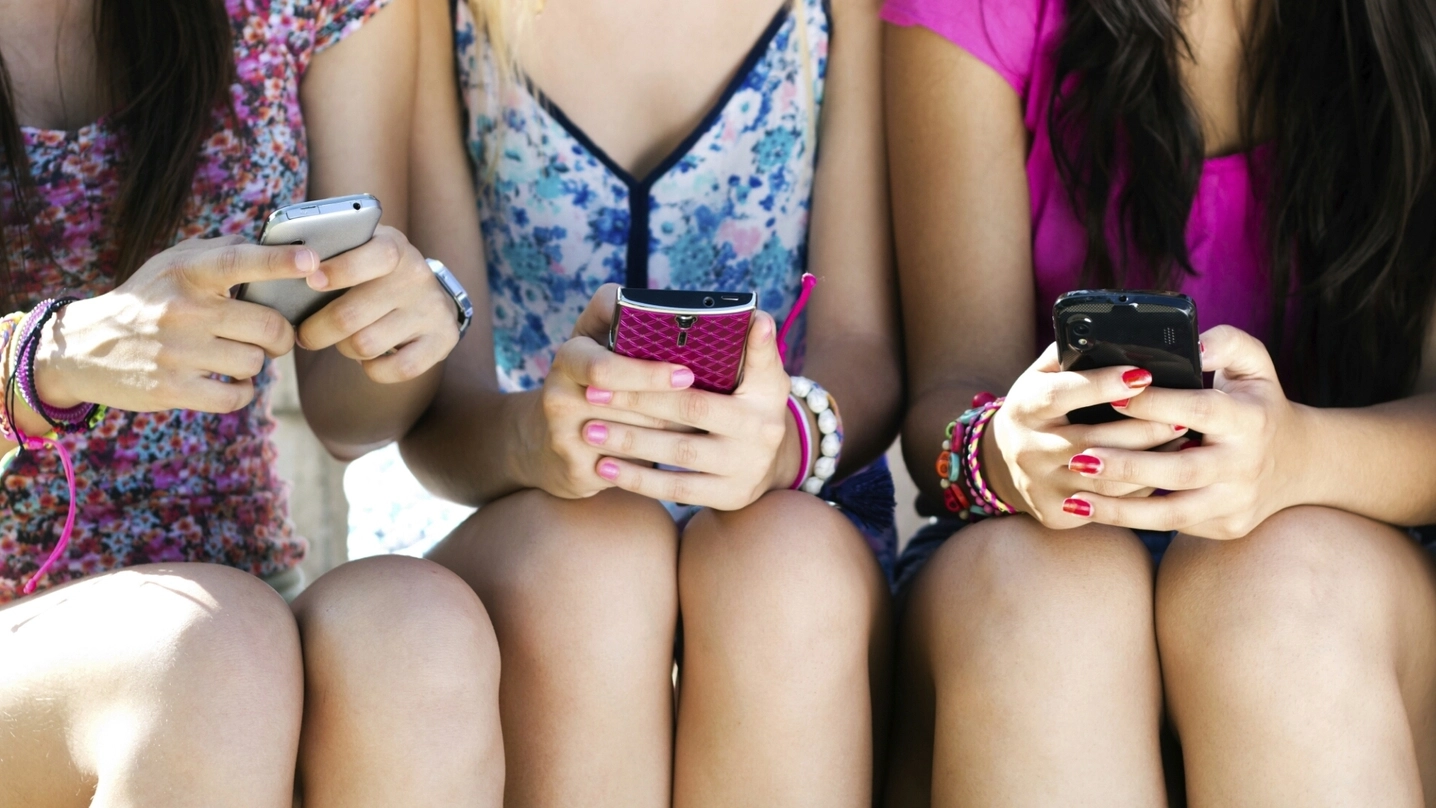 Giovani ragazze alle prese con i loro cellulari (foto repertorio)
