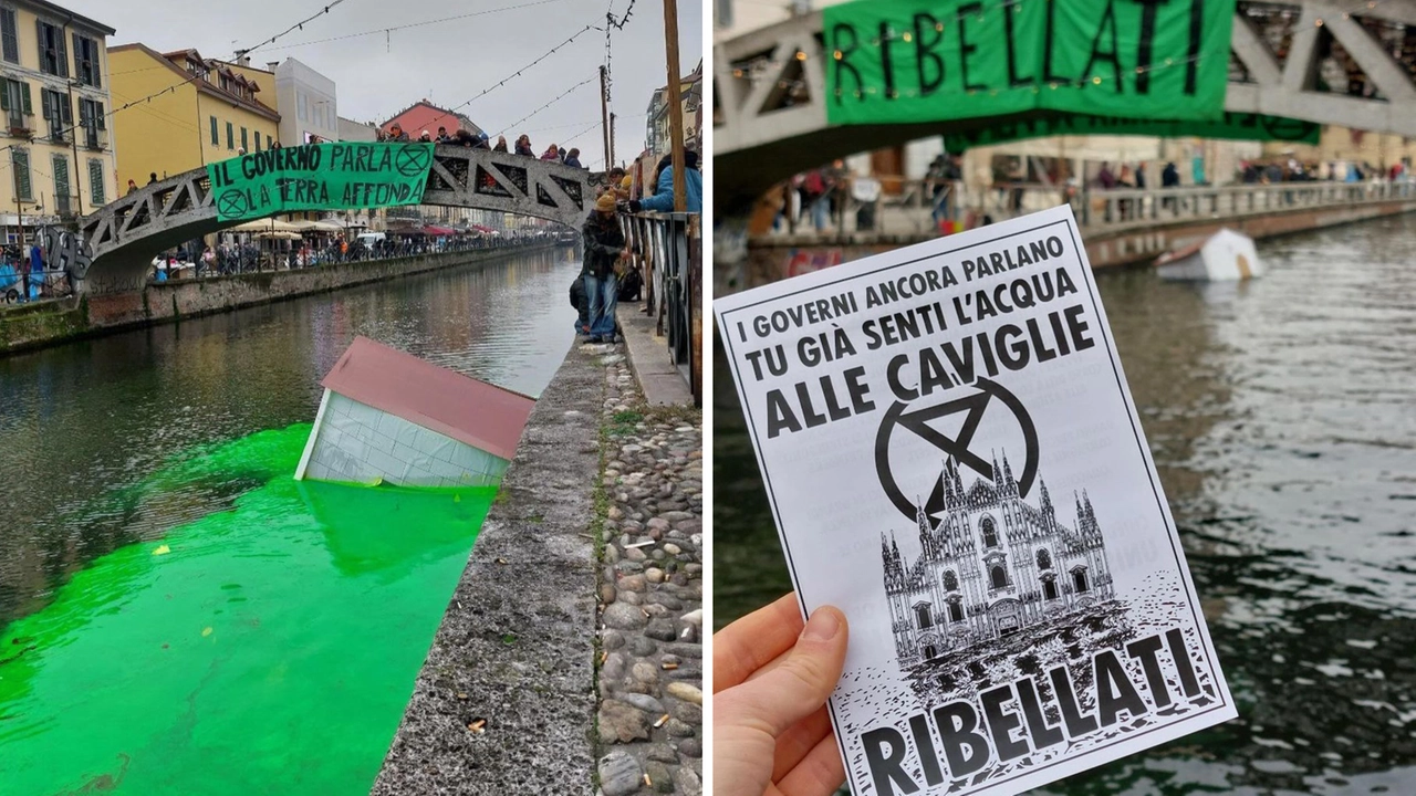 Le acque del Naviglio tinte di verde e lo striscione di Extinction Rebellion: "Il governo parla, la Terra affonda"