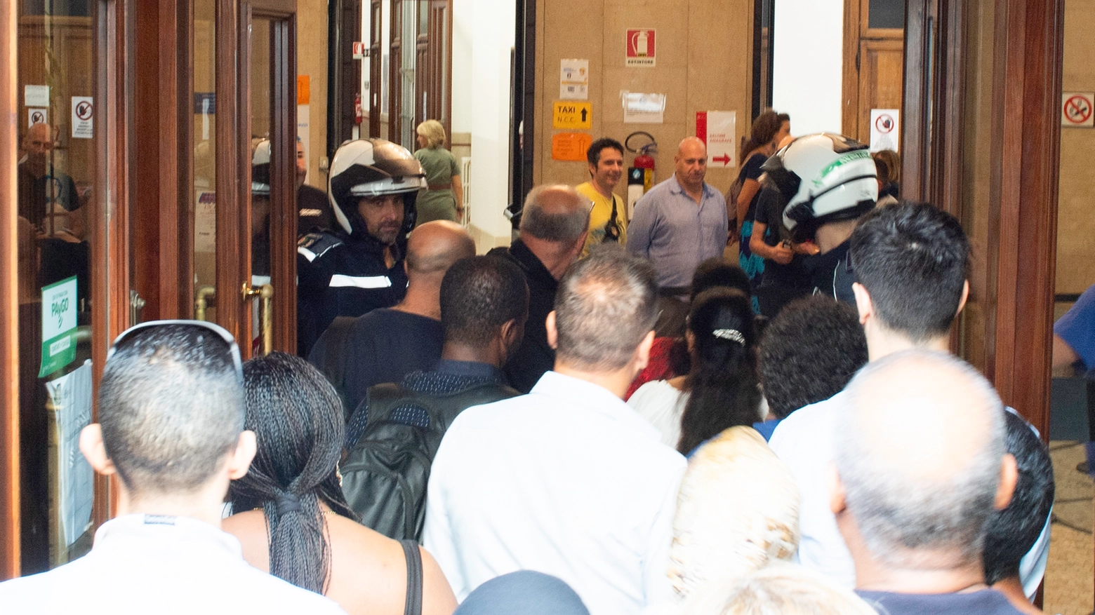 Vigili all'ingresso dell'Anagrafe di via Larga per gestire la coda