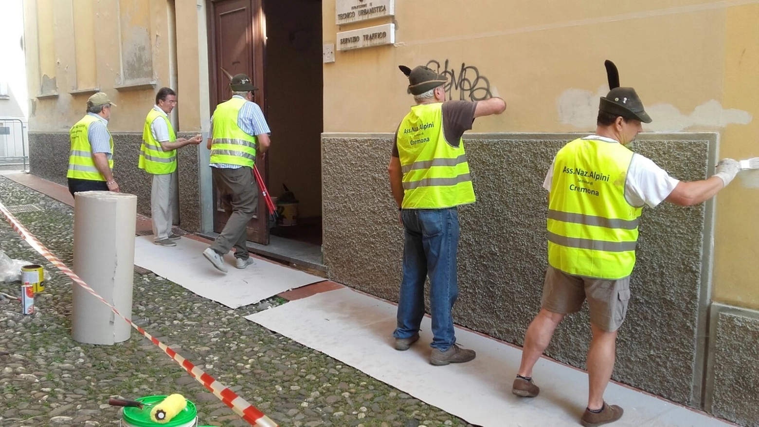 Alpini al lavoro per pulire le scritte sui muri