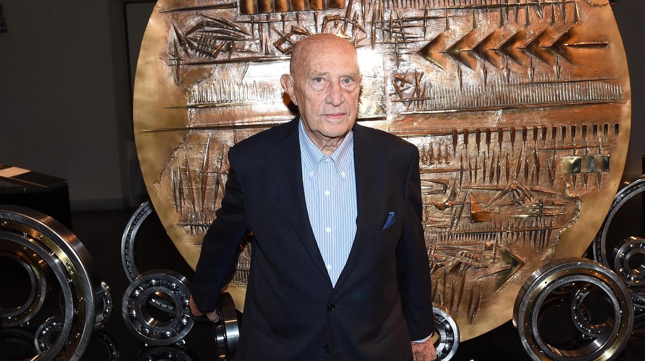 Arnaldo Pomodoro posa davanti a una sua opera in bronzo