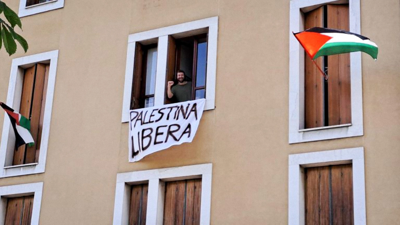 Giulio Tonincelli nell'appartamento da cui ha esposto lo striscione e la bandiera in favore della Palestina Giulio Tonincelli nell'appartamento da cui ha esposto lo striscione e la bandiera in favore della Palestina