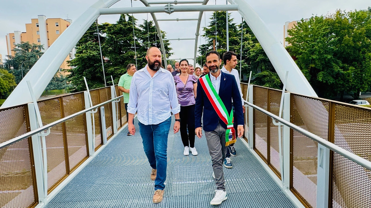 Sopra, la passerella ciclopedonale sulla Val Tidone nelle frazione di Noverasco A sinistrfa e sotto, l’inaugurazine con il sindaco di Opera Ettore Fusco