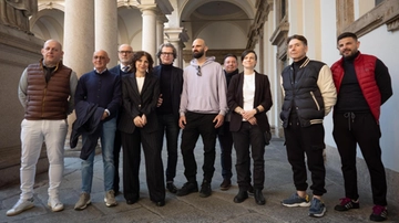 Opera, il murale dei detenuti-artisti. La “trasformazione“ in 60 metri: "Le linee come il tempo in carcere"