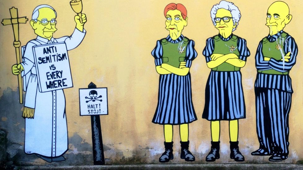 Ennesimo atto vandalico contro due opere di aleXsandro Palombo, nel mirino anche Sami Modiano. Lo street artist: "Attaccare i superstiti di Auschwitz è la prova che democrazia e libertà sono in pericolo".