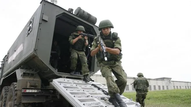 Russian Special Forces soldiers from the army's Intelligence unit comes out of a Taifun (Typhoon), a mine-resistant armoured vehicle, at a training ground during a military drill near the village of Molkino, Krasnodar region, on July 10, 2015.  AFP PHOTO / SERGEI VENYAVSKY