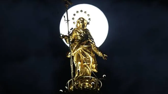 The moon rises behind the Holy Mary statue atop the main spire of the Duomo Cathedral in Milan, Italy, Monday, Nov. 14, 2016. The brightest moon in almost 69 years lit up the sky, during its closest approach to earth as the "Supermoon" reached its most luminescent phase. The moon won't be this close again until Nov. 25, 2035. (ANSA/AP Photo/Luca Bruno)