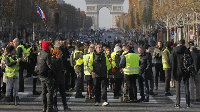 Protesters blocs the Champs Elysees avenue to protest fuel taxes in Paris, France, Saturday, Nov. 17, 2018. France is bracing for a nationwide traffic mess as drivers plan to block roads to protest rising fuel taxes, in a new challenge to embattled President Emmanuel Macron. (ANSA/AP Photo/Michel Euler) [CopyrightNotice: Copyright 2018 The Associated Press. All rights reserved.]