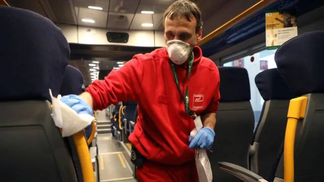 A member of the Cleaning Service staff sanitizes a convoy of the Trenord railway company at the Garibaldi train station in Milan, northern Italy, following the coronavirus outbreak, 25 February 2020.
ANSA / MATTEO BAZZI