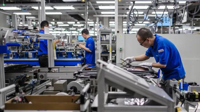 epa08176605 (FILE) - Workers pictured during a visit of German Chancellor (not in the picture) to Webasto factory in Wuhan, China, 07 September 2019 (Reissued 29 January 2020). The German car supplier Webasto has confirmed the infection of several employees with the novel coronavirus. They were reportedly infected at the company's headquarters last week by an employee from Webasto China. Webasto has several factories in China, including in Wuhan, the city at the center of the coronavirus outbreak. The company said in a statement that they stopped all travelling from and to China for at least two weeks and that all employees in Stockdorf were free to work from home for a week.  EPA/CLEMENS BILAN