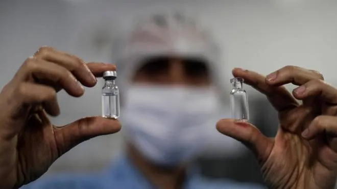 epa08590645 View of two vials with vaccine samples, in the laboratory of BioManguinhos, the institute for the production of immunobiologicals of the Oswaldo Cruz Foundation, in Rio de Janeiro, Brazil, 07 August 2020. Brazil, one of the countries in which the vaccine against the novel coronavirus developed by the British University of Oxford is being tested, expects to begin mass production of it in December, the state laboratory responsible reported on 07 August. BioManguinhos will also receive, in all its phases, the technology for the production in Rio de Janeiro of the vaccine starting next year.  EPA/Antonio Lacerda