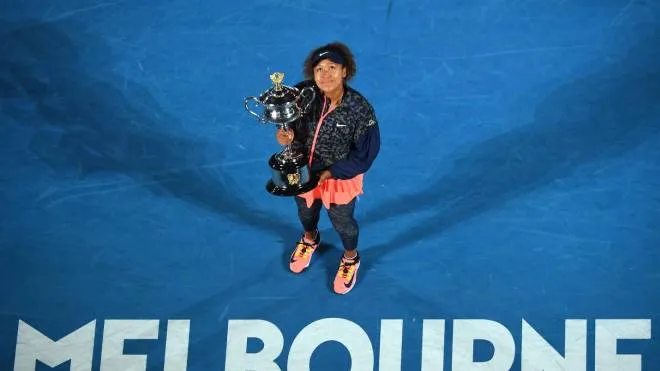 epa09025514 Naomi Osaka of Japan holds the trophy after winning the women's singles final against Jennifer Brady of the United States on day 13 of the Australian Open tennis tournament at Rod Laver Arena in Melbourne, Australia, 20 February 2021.  EPA/JAMES ROSS  AUSTRALIA AND NEW ZEALAND OUT
