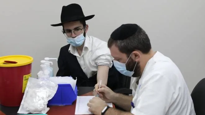 An Ultra orthodox Jewish man receives a COVID-19 vaccine from a nurse at Ichilov Medical Center in a Yeshiva at the Ultra orthodox city of Bnei Brak, Israel, 11 February 2021. Israel begin a vaccinations campaign at the ultra orthodox community, as Israel has so far vaccinated over three million of its around nine million citizens with the first dose of the coronavirus and two million have been given the second dose ANSA/ABIR SULTAN