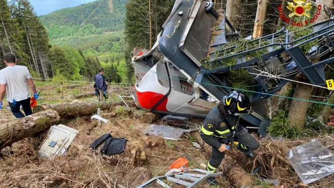 Rescuers at work on the place where a cable car crashed in Mottarone Stresa, near Turin, Italy, 23 May 2021. Fourteen victims and one seriously injured person is at the moment the death toll of the disaster.  ANSA / Italian Firemen handout  +++ ANSA PROVIDES ACCESS TO THIS HANDOUT PHOTO TO BE USED SOLELY TO ILLUSTRATE NEWS REPORTING OR COMMENTARY ON THE FACTS OR EVENTS DEPICTED IN THIS IMAGE; NO ARCHIVING; NO LICENSING +++