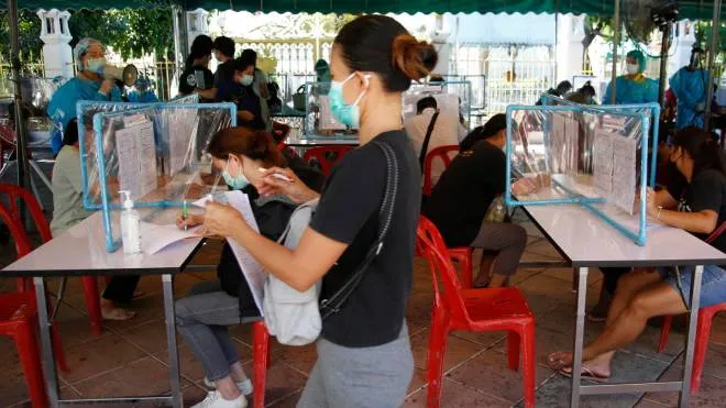 epa09323073 Thai local villagers register for a COVID-19 nasal swab test during the speeds up testing in a bid to curb the rapid spreading of the pandemic, at Wat Phra Sri Mahathat in Bangkok, Thailand, 05 July 2021. Thailand has seen high numbers of new COVID-19 infections, with Bangkok remaining the largest cluster of the Delta variant according to Thailand's department of Medical Sciences. Thailand's recent reimposing of COVID-19 restrictions continues, including banning dine-in services at restaurants and shutdown of all construction sites, as the outbreak shows no immediate signs of slowing down.  EPA/NARONG SANGNAK