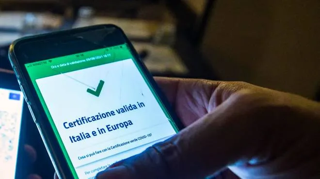 A visitor's Covid-19 Green Pass is checked at the entrance to a restaurant in Rome, Italy, 09 August 2021. ANSA/ANGELO CARCONI