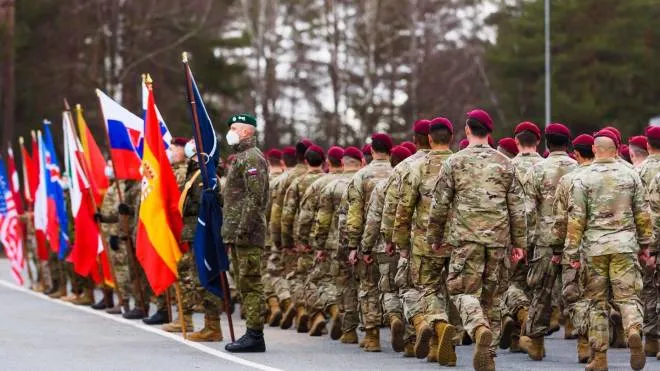 Soldiers of an airborne brigade of the US Army are seen at the Adazi Military Base of the Latvian armed forces in Adazi, Latvia on February 25, 2022, upon arrival for their mission to strengthen the NATO enhanced Forward Presence (eFP) multinational battlegroup in the wake of Russia's military aggression of Ukraine. (Photo by Gints Ivuskans / AFP)