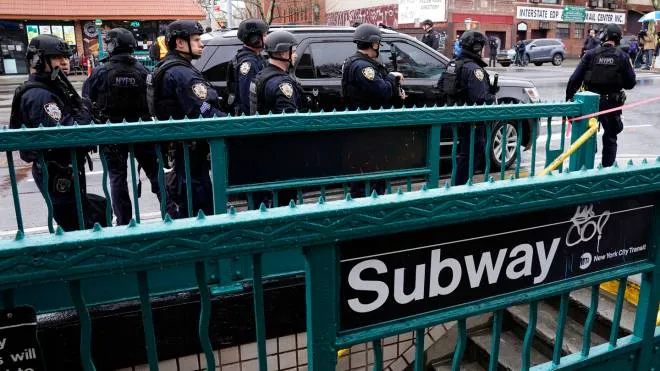 Members of the New York Police Department patrol the streets after at least 13 people were injured during a rush-hour shooting at a subway station in the New York borough of Brooklyn on April 12, 2022, where authorities said "several undetonated devices" were recovered amid chaotic scenes. - Ambulances lined the street outside the 36th Street subway station, where a New York police spokeswoman told AFP officers responded to a 911 call of a person shot at 8:27 am (1227 GMT). The suspect was still at large, according to Manhattan borough president Mark Levine. (Photo by TIMOTHY A. CLARY / AFP)