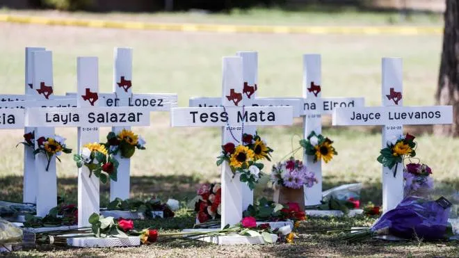 epa09978055 Crosses bearing names of some of the victims sit on the school grounds following a mass shooting at the Robb Elementary School in Uvalde, Texas, USA, 26 May 2022. According to Texas officials, at least 19 children and two adults were killed in the shooting on 24 May. The eighteen-year-old gunman was killed by responding officers.  EPA/TANNEN MAURY