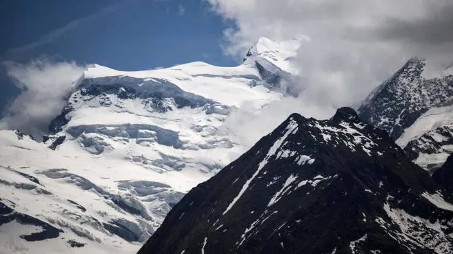 This photograph taken on May 27, 2022, shows a partial view of the Grand Combin massif mountain near Verbier, where several climbers were victims of a major fall of seracs - large blocks of ice - in southern Switzerland. - Some fifteen climbers had been in the area, the Valais cantonal police said in a statement. "Several climbers were affected. Some victims are to be deplored," it said without further details. (Photo by Fabrice COFFRINI / AFP)