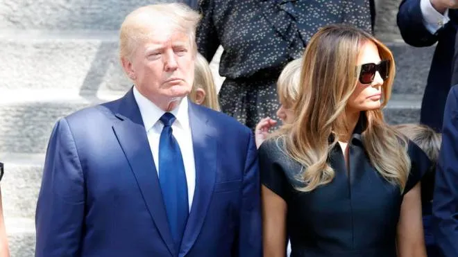 epa10082850 Former US President Donald (C) and his wife former First Lady Melania Trump, stand behind the coffin with the remains of his first wife Ivana Trump at Vincent Ferrer Roman Catholic Church in New York, New York, USA, 20 July 2022. Ivana Trump, the first wife of former President Donald Trump, has died at age 73 on 14 July 2022.  EPA/JASON SZENES