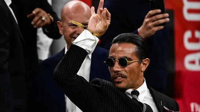 Turkish butcher, chef, food entertainer and restaurateur, Nusret Gokçe, nicknamed Salt Bae, attends the Italian Serie A football match between AC Milan and Napoli on September 18, 2022 at the San Siro stadium in Milan. (Photo by MIGUEL MEDINA / AFP)