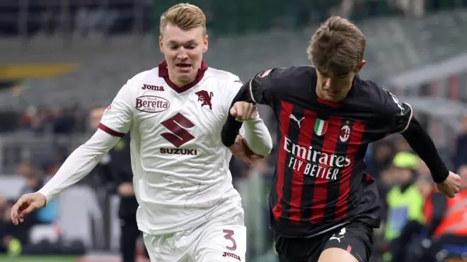AC Milan�s Charles De Ketelaere (R) challenges for the ball  Torino�s Perr Schuurs during the Italy Cup round of 16 soccer match between AC Milan and Torino  at Giuseppe Meazza stadium in Milan, 11 January 2022.
ANSA / MATTEO BAZZI