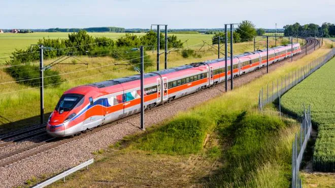 Champdeuil, France - June 1, 2022: A Frecciarossa (ETR 1000) high speed train from italian rail company Trenitalia is driving from Lyon to Paris on the LGV Sud-Est in the countryside.