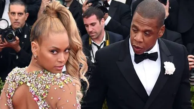 (FILES) This file photo taken on May 4, 2015 shows Beyonce and Jay Z arriving at the Metropolitan Museum of Art's Costume Institute Gala benefit in honor of the museum’s latest exhibit “China: Through the Looking Glass” in New York.   
Jay-Z's jaunty anthems made him one of rap's all-time greats and then, as he amassed a business empire and married fellow superstar Beyonce, he drew an ever thicker curtain over his private life.Releasing an album after a four-year gap, Jay-Z has bared himself like rarely before. He apologizes to Beyonce for cheating and pours out love for his mother whom he reveals to be lesbian, all while taking familiar but timely shots on the politics of race."4:44," the 13th studio album by the rapper born as Shawn Carter, came out June 30, 2017 as an exclusive on his upstart Tidal streaming service whose new part-owners, telecom provider Sprint, is banking on the release to woo customers.
 / AFP PHOTO / Timothy A. CLARY