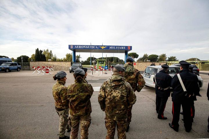 Militari attendono l'arrivo dell'aereo (Ansa)